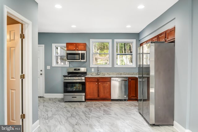 kitchen featuring sink, light tile floors, and stainless steel appliances