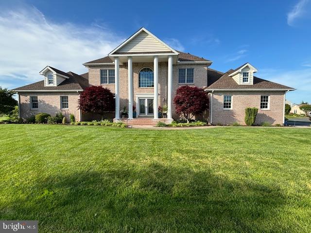 greek revival house featuring a front lawn