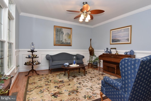 carpeted bedroom with a tray ceiling, ceiling fan, and ornamental molding