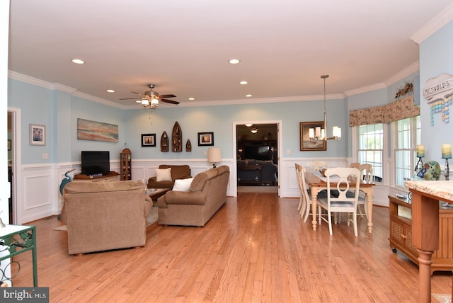 kitchen featuring stainless steel appliances, crown molding, plenty of natural light, and light hardwood / wood-style floors