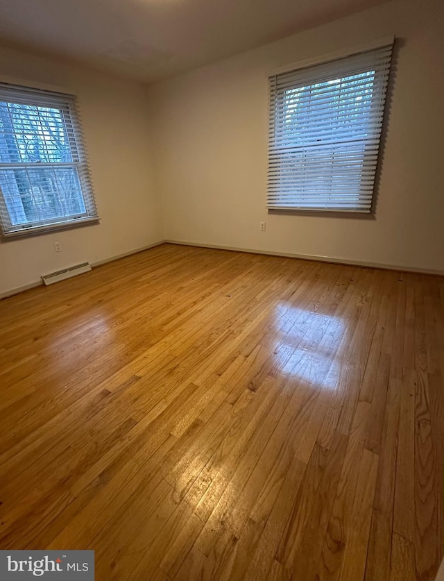 spare room with wood-type flooring and visible vents