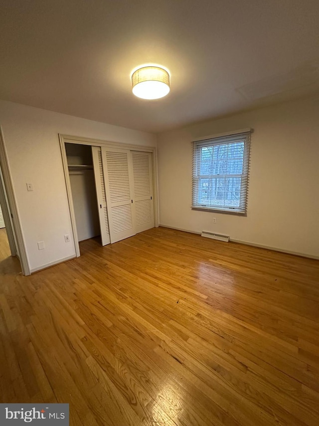 unfurnished bedroom featuring a closet and wood finished floors