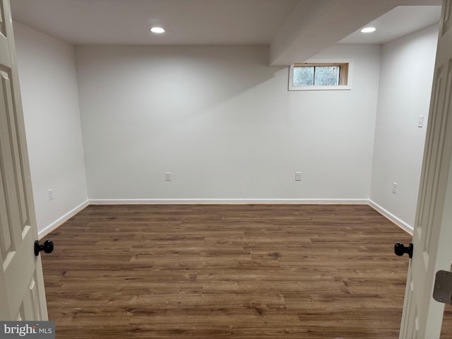 basement with dark wood-style floors, baseboards, and recessed lighting