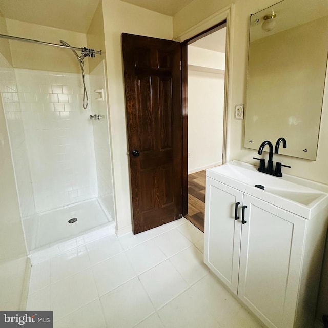 full bathroom with a shower, tile patterned flooring, and vanity