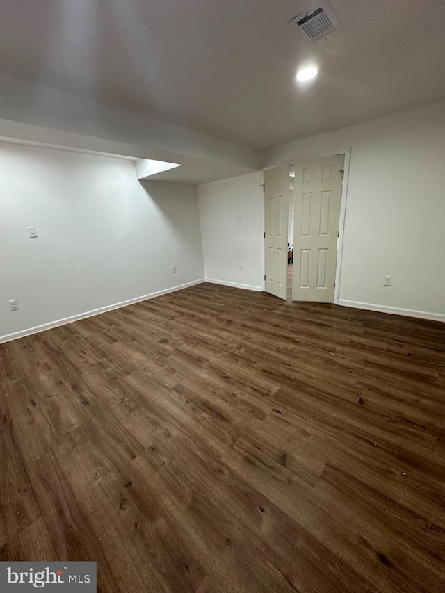 interior space featuring baseboards, visible vents, and dark wood-type flooring