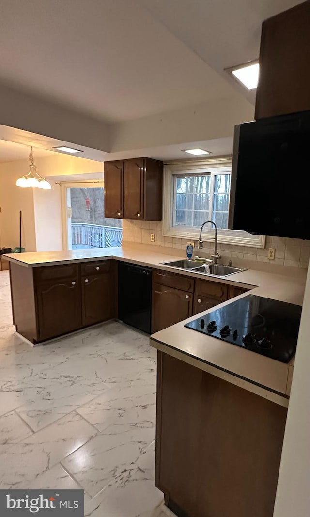 kitchen featuring black dishwasher, a sink, marble finish floor, and dark brown cabinets