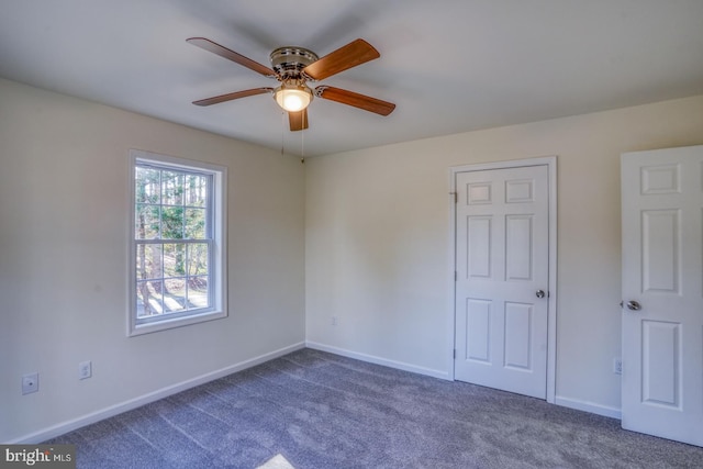 unfurnished room with ceiling fan and carpet floors