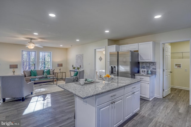 kitchen featuring stainless steel refrigerator with ice dispenser, white cabinetry, and dark wood-type flooring