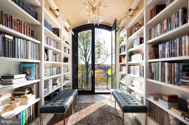 sitting room with parquet flooring, a textured ceiling, and an inviting chandelier