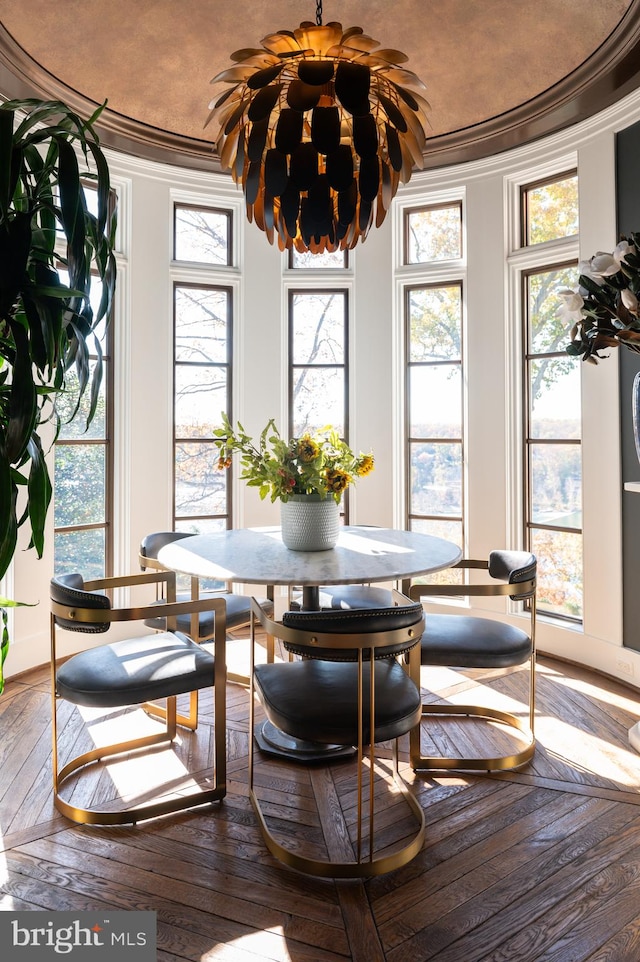 dining area featuring hardwood / wood-style flooring and crown molding