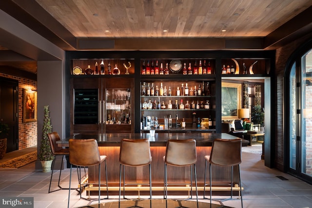 bar with beverage cooler and wood ceiling