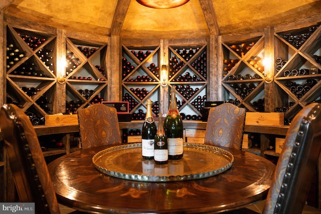 wine room with beam ceiling