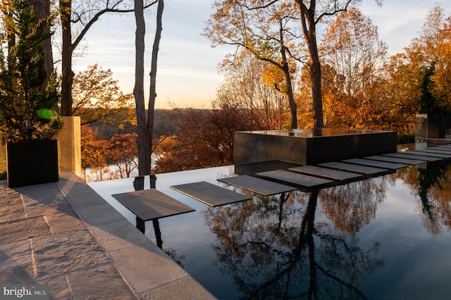 patio terrace at dusk with a water view