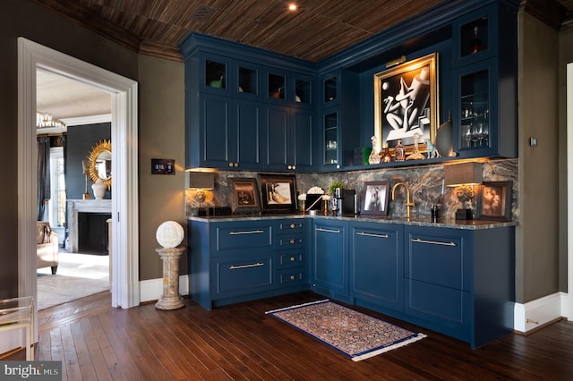 bar with blue cabinetry, wood ceiling, dark hardwood / wood-style floors, and ornamental molding