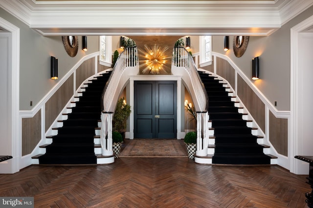 entrance foyer featuring dark parquet flooring and ornamental molding