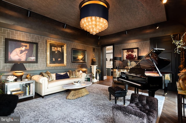 living area featuring hardwood / wood-style floors and an inviting chandelier