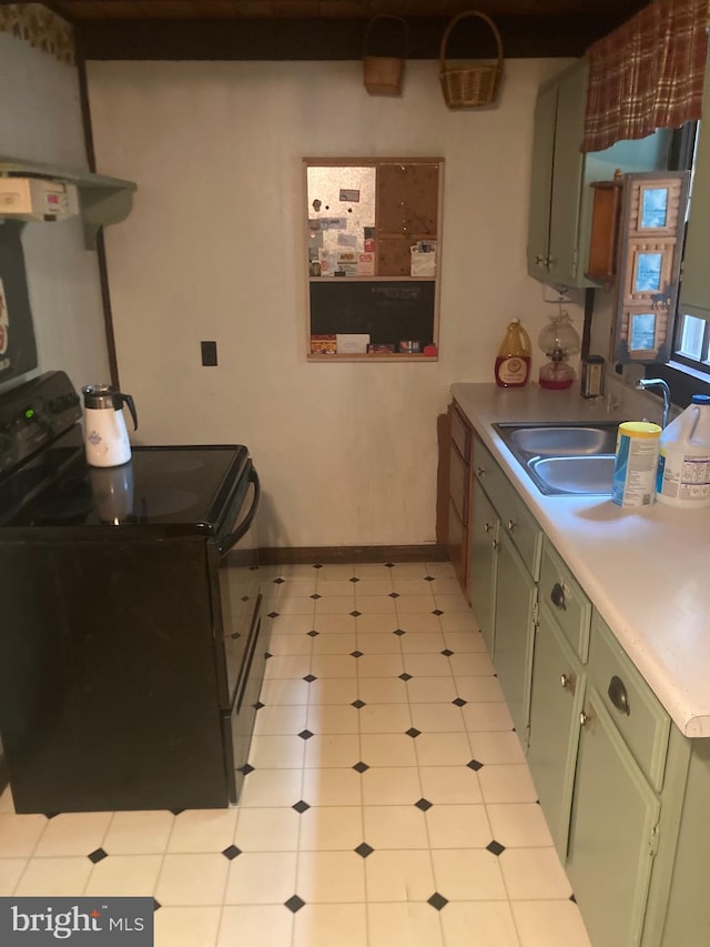 kitchen featuring black / electric stove, sink, and green cabinetry