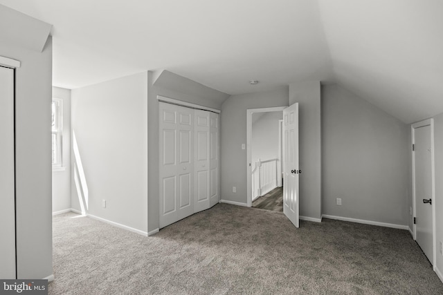 additional living space featuring vaulted ceiling and carpet