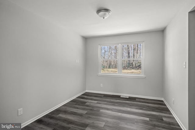 unfurnished room featuring dark hardwood / wood-style floors