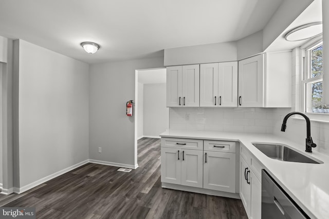 kitchen with backsplash, white cabinets, sink, and dark hardwood / wood-style floors