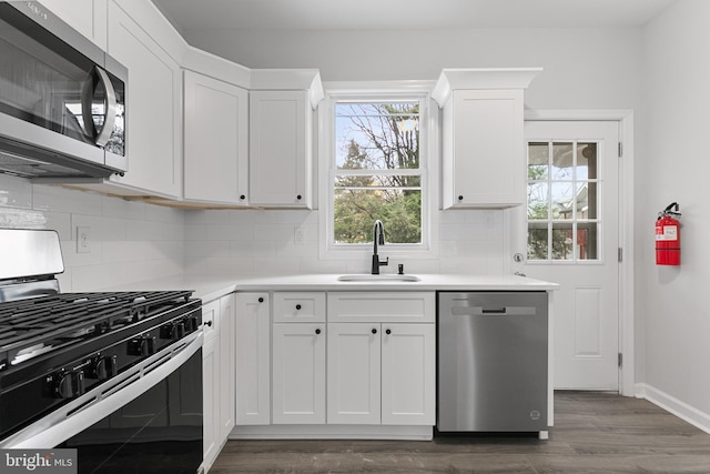 kitchen featuring white cabinetry, stainless steel appliances, sink, and dark wood-type flooring