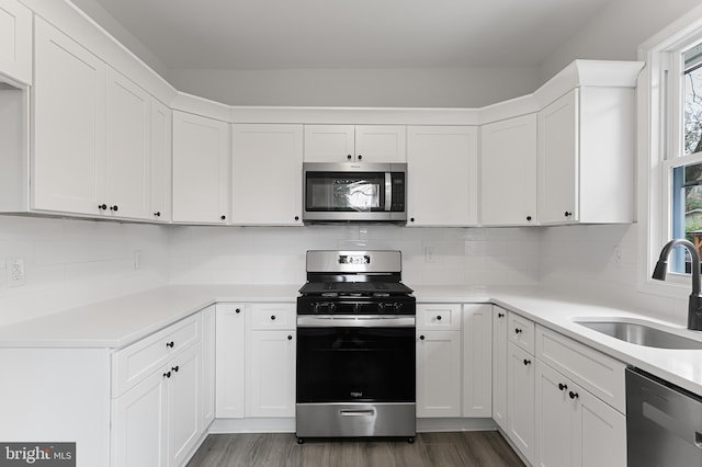 kitchen with backsplash, appliances with stainless steel finishes, and plenty of natural light