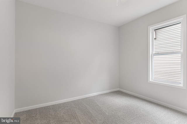 carpeted empty room featuring plenty of natural light