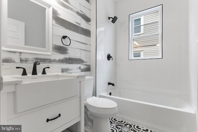 full bathroom with tiled shower / bath, backsplash, tile floors, toilet, and vanity