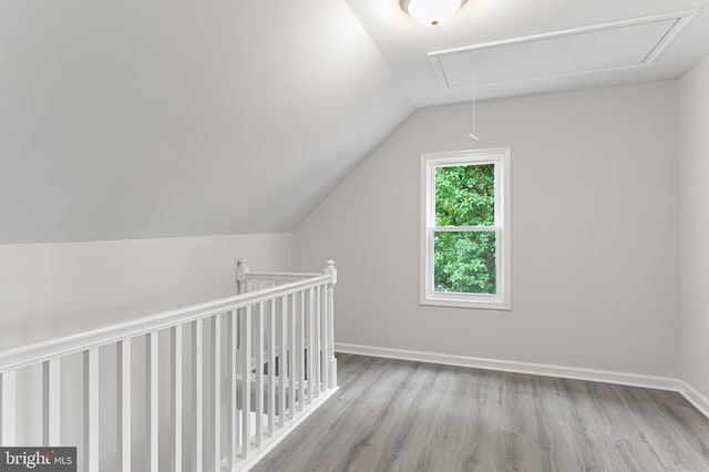 bonus room with light hardwood / wood-style floors and lofted ceiling