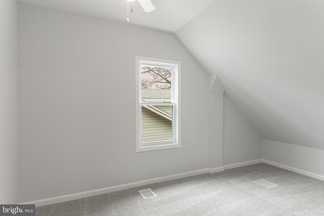 additional living space featuring ceiling fan, vaulted ceiling, and carpet floors