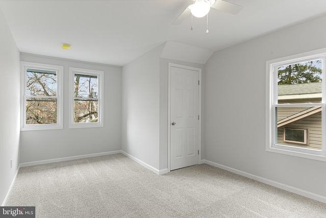 carpeted spare room with ceiling fan