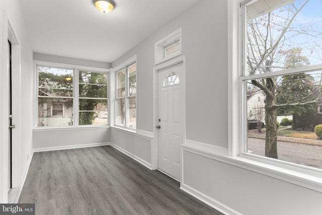 foyer with a healthy amount of sunlight and dark hardwood / wood-style flooring