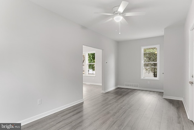 unfurnished room with ceiling fan and hardwood / wood-style floors