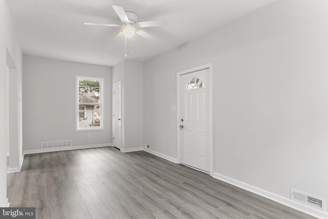 entrance foyer with ceiling fan and wood-type flooring