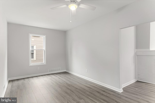 empty room featuring ceiling fan and hardwood / wood-style floors