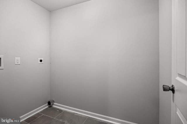 clothes washing area featuring dark tile flooring, electric dryer hookup, and hookup for a washing machine