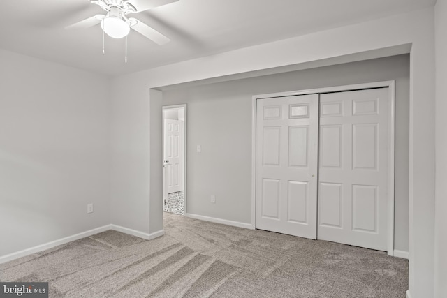 unfurnished bedroom with a closet, ceiling fan, and carpet floors