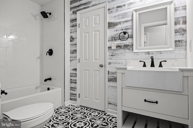 full bathroom with tiled shower / bath combo, tile flooring, toilet, and vanity