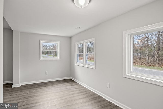 unfurnished room with hardwood / wood-style floors