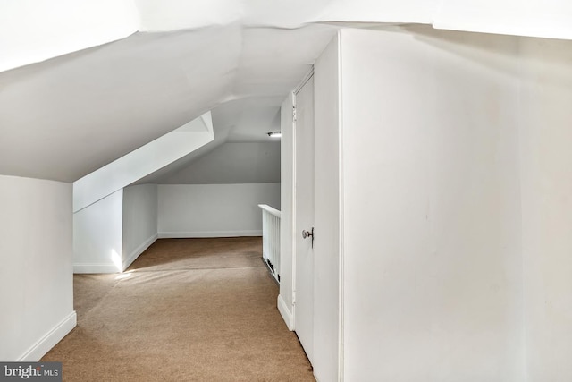 bonus room featuring light colored carpet and lofted ceiling