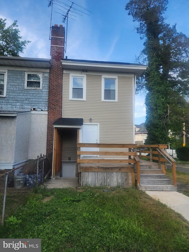 back of house with a wooden deck