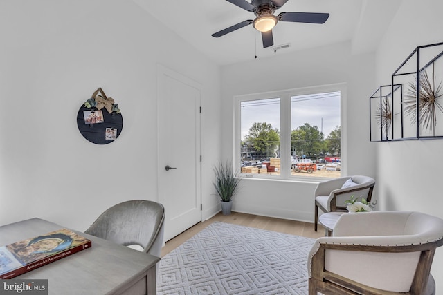 office space featuring ceiling fan and light hardwood / wood-style floors