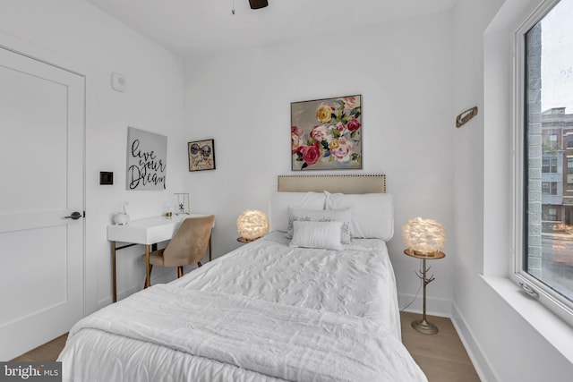 bedroom with light hardwood / wood-style floors and ceiling fan