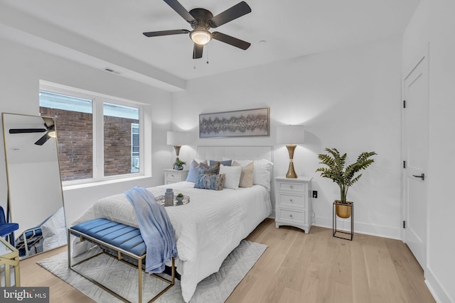 bedroom with light hardwood / wood-style floors and ceiling fan