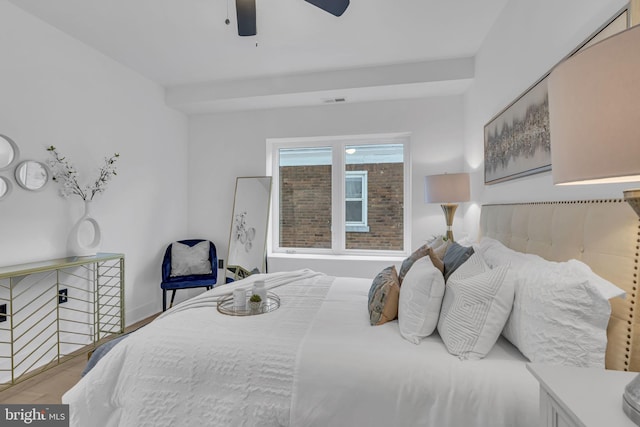 bedroom with ceiling fan and hardwood / wood-style flooring