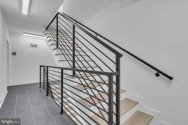 stairway featuring tile patterned floors