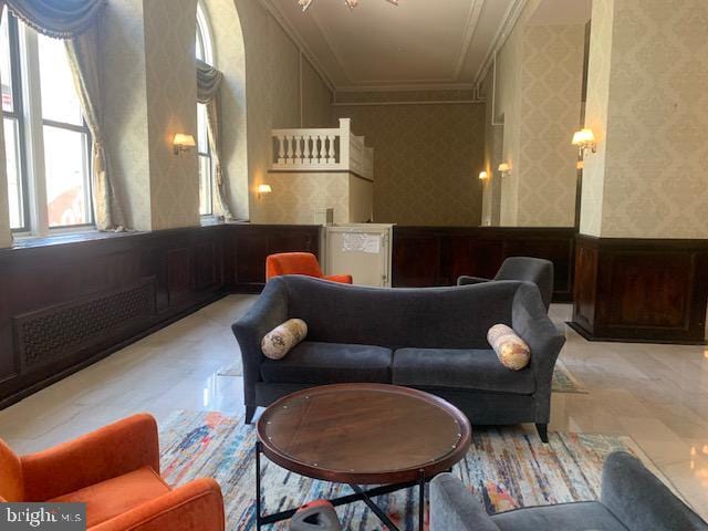 living room featuring radiator and ornamental molding