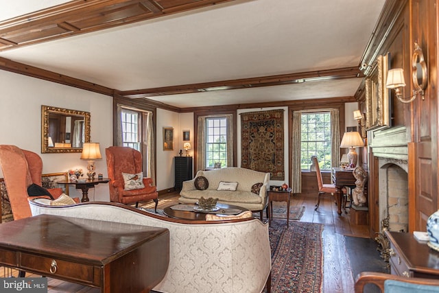 living room with ornamental molding, hardwood / wood-style floors, and beam ceiling