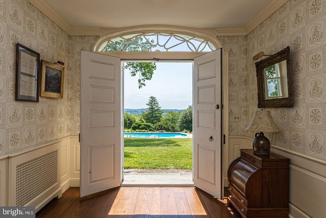 entrance foyer with crown molding and hardwood / wood-style flooring