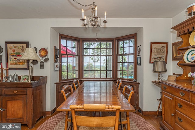 dining room with wood-type flooring and a chandelier